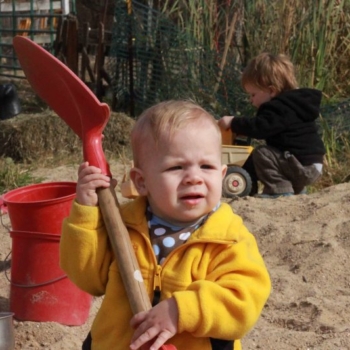 Baby holding shovel
