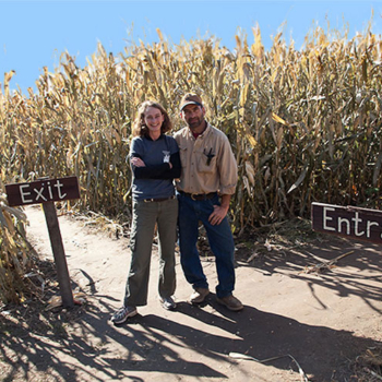 Alan and Angie Treinen standing at entrance to corn maze