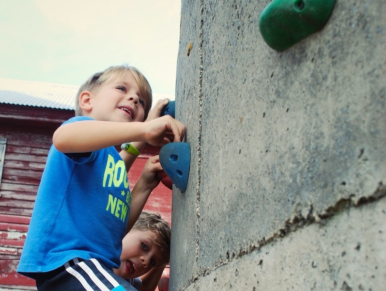 Children scaling climbing wall at Treinen Farm Children scaling climbing wall at Treinen Farm