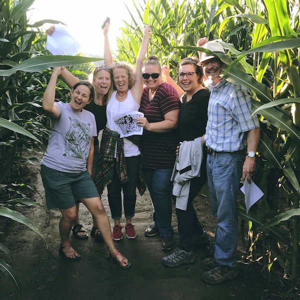 People posing for group photo in corn maze